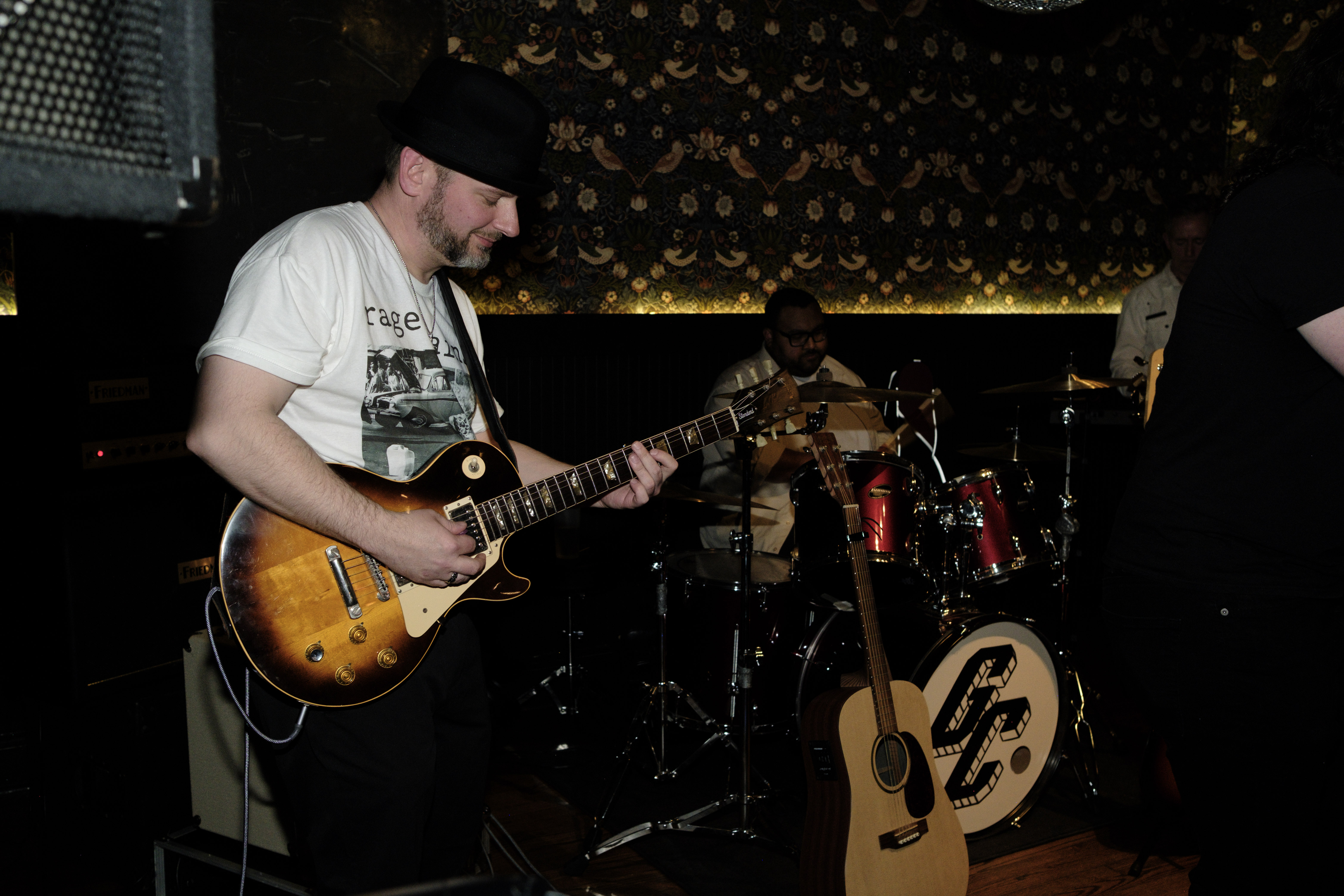 Lead guitarist with Les Paul, drums visible in background