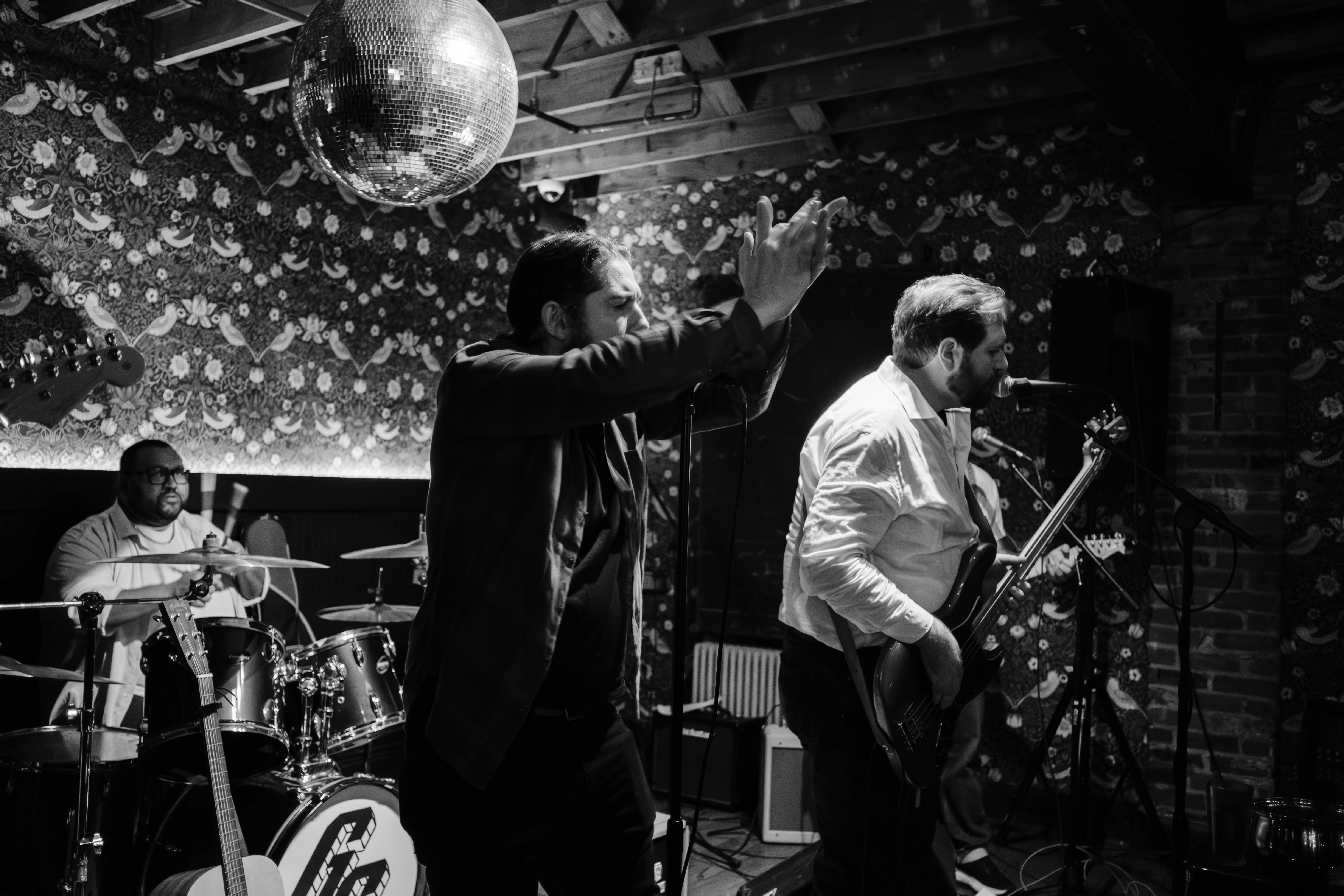 B&W wide shot, vocalist and guitarist performing